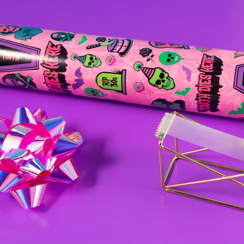 40th birthday Vibrant wrapping paper featuring a playful goth theme with illustrations of skulls, birthday cakes, and caskets marked "RIP 30s", set against a pink background with green accents. Ideal for themed 40th birthday gifts.